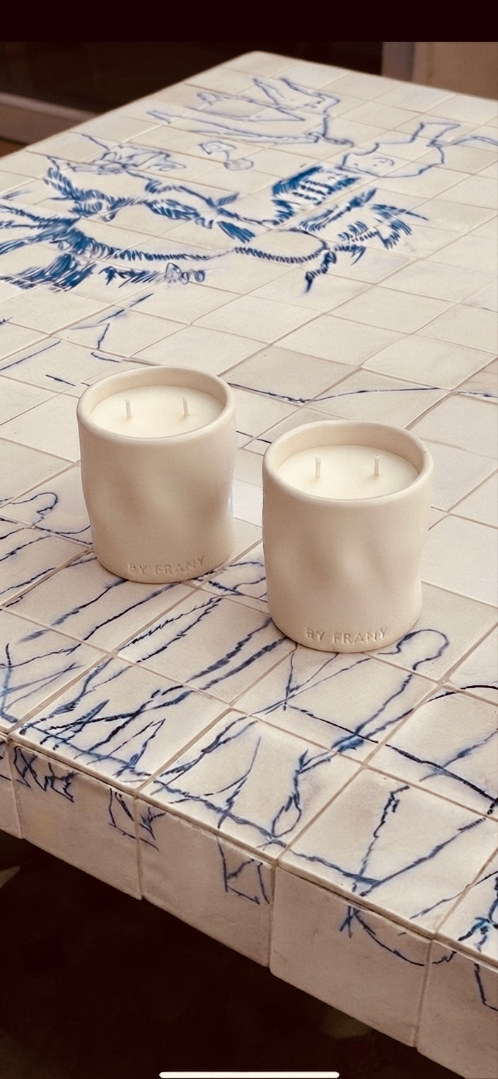 By Frany candles in ceramic vessels on a tiled surface